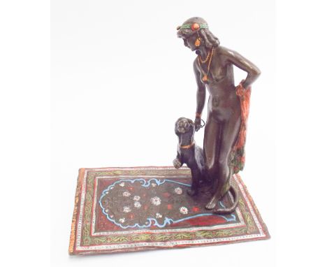 Cold painted bronze model of a Middle Eastern dancing girl with panther on a carpet, 16 x 10cm x 16cm tall 