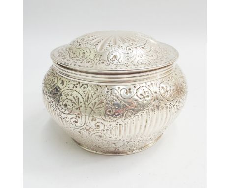 Georgian silver tea caddy of circular form, hinged lid with later all over trailing flower and leaf decoration with gadrooned
