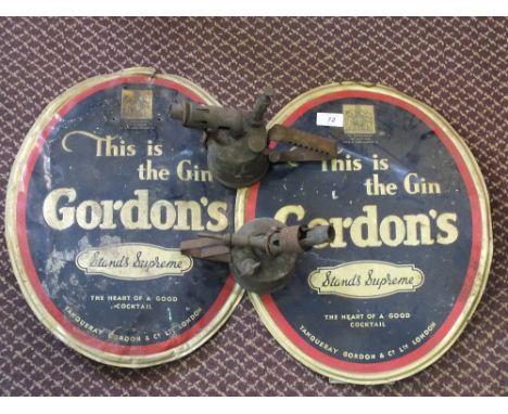 Two oval aluminium Gordons Gin signs and two Brass blowlamps
