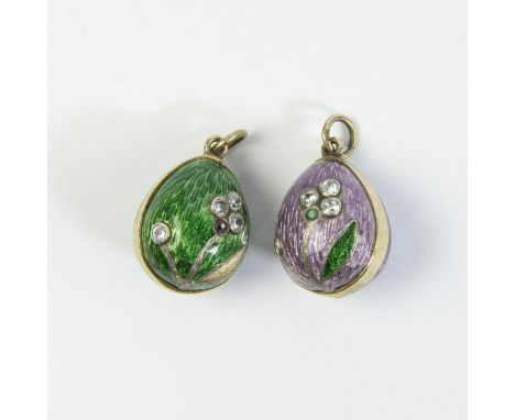 A pair of Russian imperial silver and enamel pendants in the shape of an Easter egg. The outside of the egg is covered with p