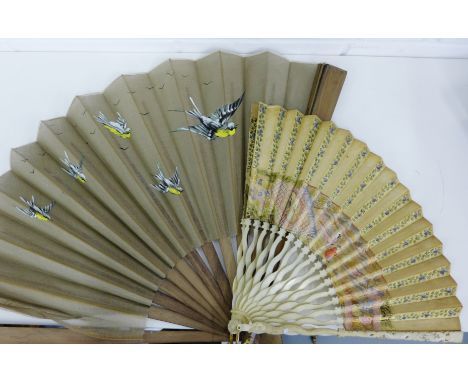 An ivory handled and painted fan together with a larger fan with bird painted panel (2) 