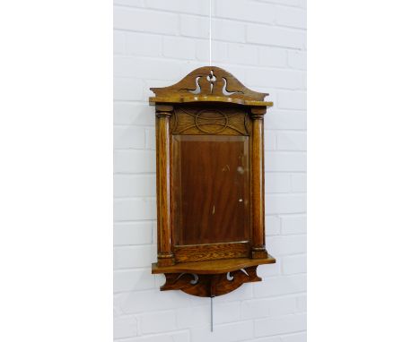 Oak framed wall mirror with pierced frieze to top, the bevelled plate flanked by pilasters and with shelf to base, 80 x 40cm 