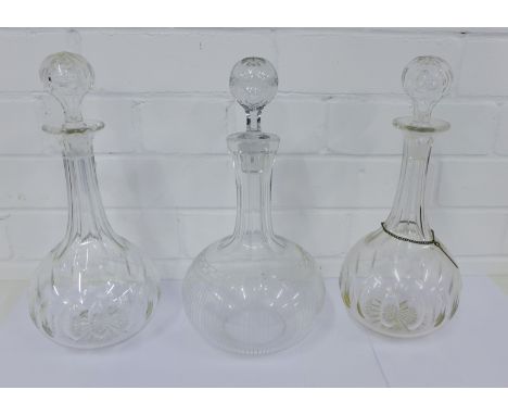 A pair of 19th century facet cut globe and shaft decanters and stoppers together with an etched glass decanter and stopper (3