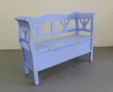 Duck egg blue painted bench with shaped and open back and scroll arms, the seat with a lift up compartment, raised on stile f