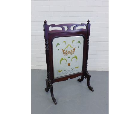 An Art Nouveau mahogany fire screen with stylised stained glass insert on turned and reeded supports and splayed feet, 90 x 5