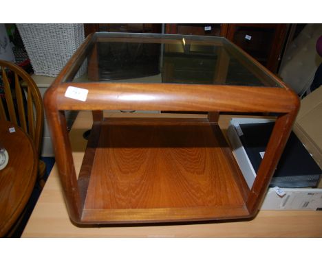 A "G plan" style Teak framed glass-top occasional table on castors with a lower shelf.