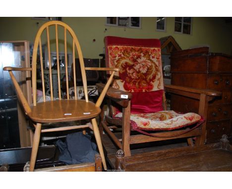 An Oak framed armchair (adjustable) and a stick back open-armed elbow/carver chair.
