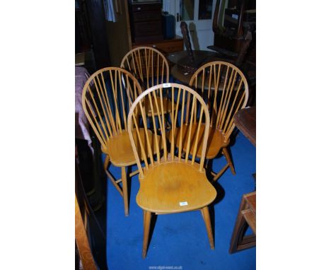 Four stick back dining chairs.