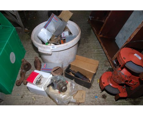 A bucket containing tractor parts, filters, bearings and International Harvester steering arm.