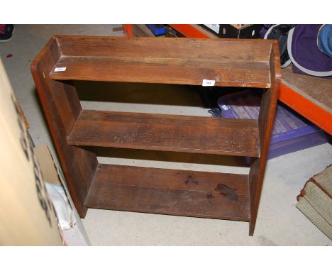 A three shelf, open back, floor standing bookshelf.