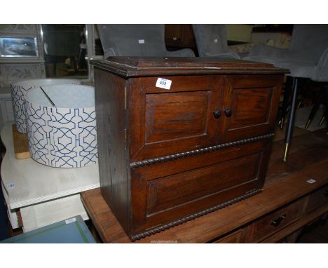 A small oak cupboard with centre shelf, 22" x 11 1/2" x 19" high.