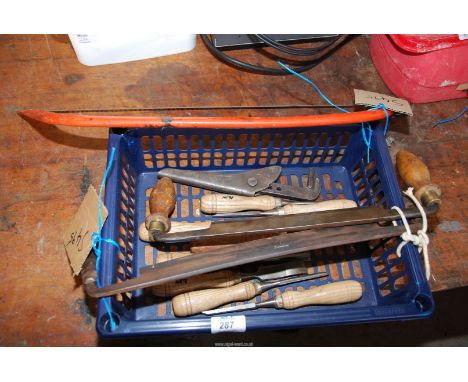 A bow saw, wood working tools, two draw-planes, woodworking lathe chisels.