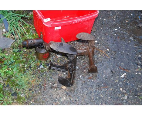 Two shoe lasts and a blow lamp.