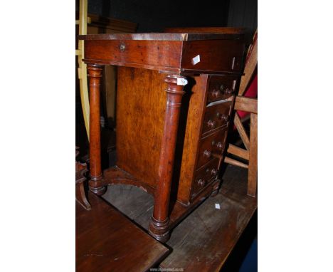 A compact Mahogany/Walnut Davenport with four true drawers and four false drawers to the sides.