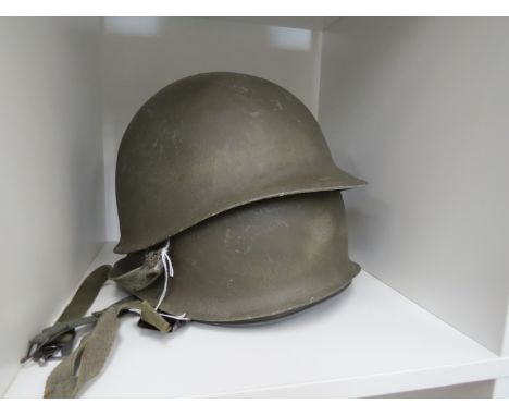 Two post war US army helmets with liners 