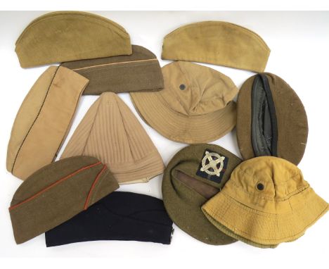 A box of WWII and post-war hats including WWII Indian Kula, officers beret, soldiers side hats, two Russian side hats, US WWI
