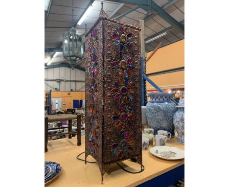 A MIDDLE EASTERN PIERCED GILT METAL FLOOR LANTERN WITH FLORAL MOTIFS HAVING COLOURED GLASS PETALS ( 9 X 31 INCHES ) 
