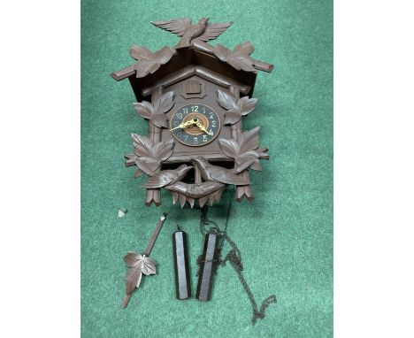 A DECORATIVE WOODEN CUCKOO CLOCK WITH WEIGHTS 