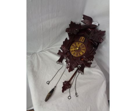 A BATTERY OPERATED WOODEN CUCKOO CLOCK 