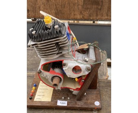 A MODEL OF A FOUR STROKE ENGINE ON A WOODEN PLINTH 