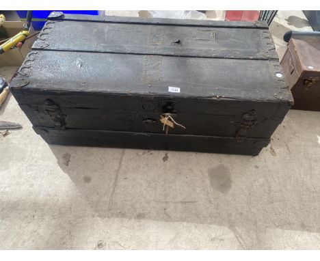 A LARGE VINTAGE TRUNK WITH WOOD BINDING 