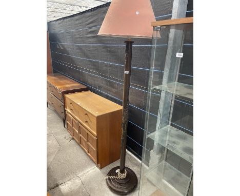 A MID 20th CENTURY CARVED HARDWOOD STANDARD LAMP COMPLETE WITH SHADE 