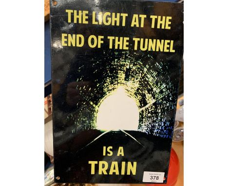 A METAL SIGN"THE LIGHT AT THE END OF THE TUNNEL IS A TRAIN" 