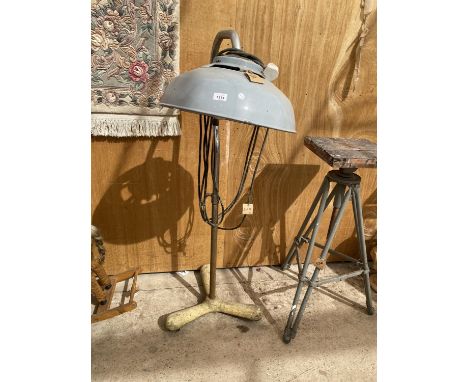 AN INDUSTRIAL STYLE LAMP ON A HEAVY CAST IRON BASE 