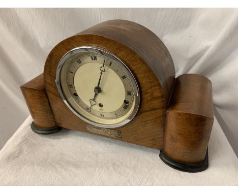AN ART DECO EIGHT DAY STRIKING WALNUT MANTEL CLOCK WITH PRESENTATION PLAQUE AND KEY 