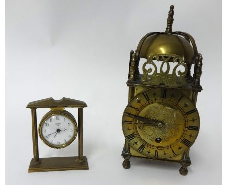 A reproduction brass lantern clock and a miniature Swiza desk clock