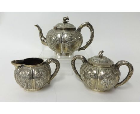 Chinese export silver three piece tea service with bamboo decoration, each piece inscribed 'Presented to Dr R.Gibson by Mr Ko