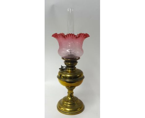 Brass oil lamp with cranberry glass shade, 46cm