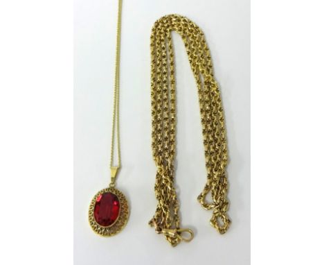 A 9ct gold long fancy link necklace, 27g yellow metal pierced ruby style pendant on chain