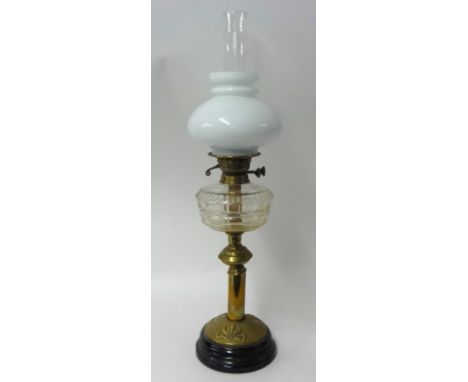 Brass oil lamp with glass reservoir and milk glass shade, 61cm