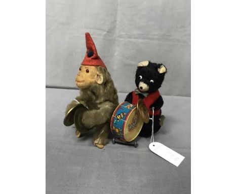 FIVE VINTAGE CLOCKWORK TOYScomprising of a Schuco clown, a monkey with cymbals, a bear with a drum and two cats 