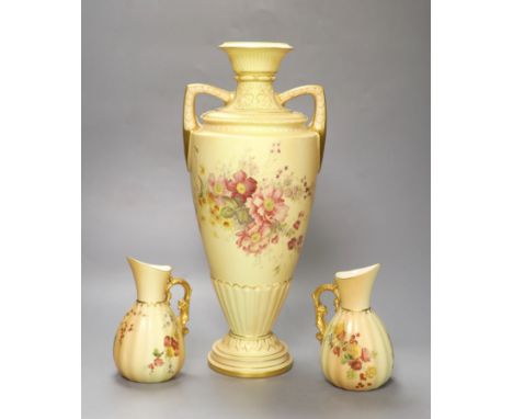 A Royal Worcester two-handled blush ivory vase, decorated with flowers, height 38cm, and a pair of similar jugs