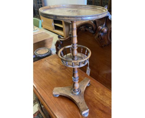 An early Victorian circular rosewood candlestand with galleried shelf on platform base, diameter 35cm, height 72cm