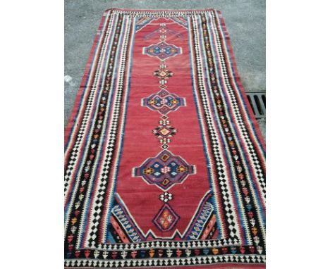 A Kelim flatweave carpet, 340 x 172cm (holed)