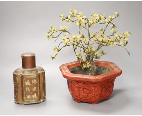 A Chinese hardstone miniature tree in hexagonal cinnabar lacquer jardiniere and a lacquered pewter tea caddy of quatrefoil fo