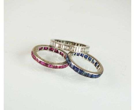 A ruby set full hoop eternity ring, the bright cut engraved shank stamped 'Plat', together with a sapphire set full hoop eter