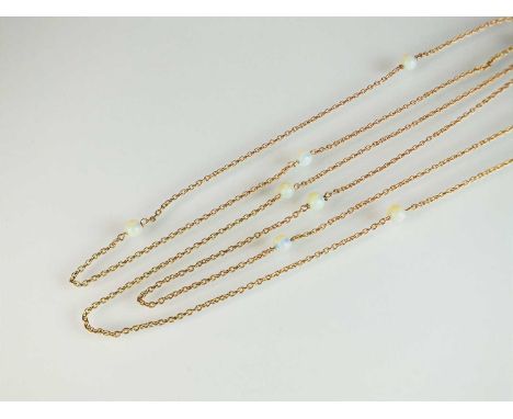 An opal bead guard chain, the yellow metal chain set with ten polished spherical opal beads, with bolt ring clasp and plaque 