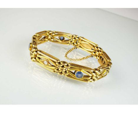 A sapphire and diamond stylised gate link bracelet, designed as eight alternating diamond and sapphire set yellow metal links