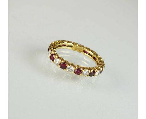 An 18ct gold ruby and diamond full eternity ring by Boucheron, the alternating rubies and diamonds claw set in yellow gold, t