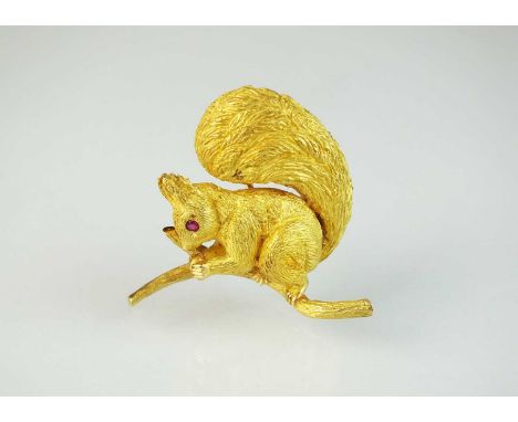 A French gold Hermes brooch in the form of a squirrel, with textured 'fur' body, ruby set eye and naturalistically modelled s