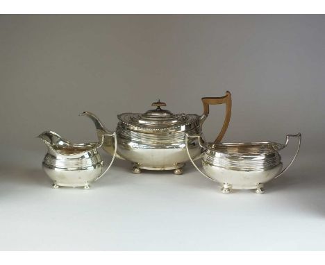 A three piece silver tea service, Mappin &amp; Webb, Sheffield 1913 &amp; 1914, each piece of oval form with reeded border an