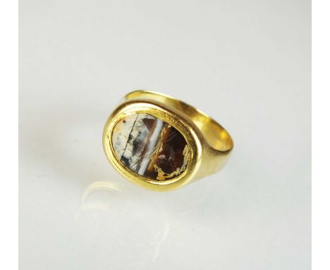 A banded agate intaglio ring, depicting a man on horseback holding a spear, the yellow metal mount not stamped, ring size R, 