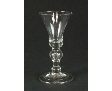 A heavy baluster wine glasscirca 1710-20the bell bowl set above an inverted baluster with tear and a basal knop issuing from 