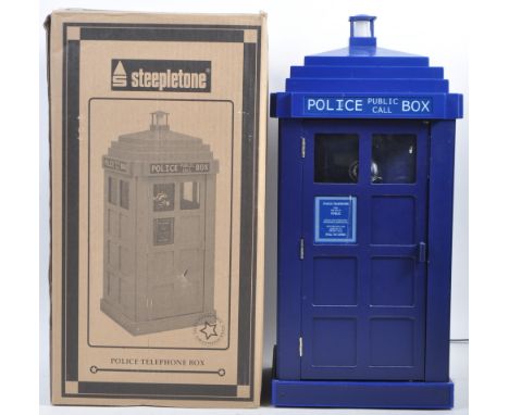 A large wall mounted retro novelty Police telephone box in the manner of a Doctor Who / Dr Who Tardis. The dark blue phone bo