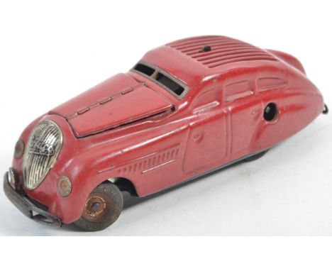 A scarce vintage Schuco made Kommando Anno 2000 clockwork tinplate model car. Highly detailed, with twin-opening bonnet and d