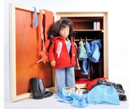 An original vintage circa 1970's vinyl Sasha doll with clothing items and a hand made wardrobe. The doll having dark brown ro
